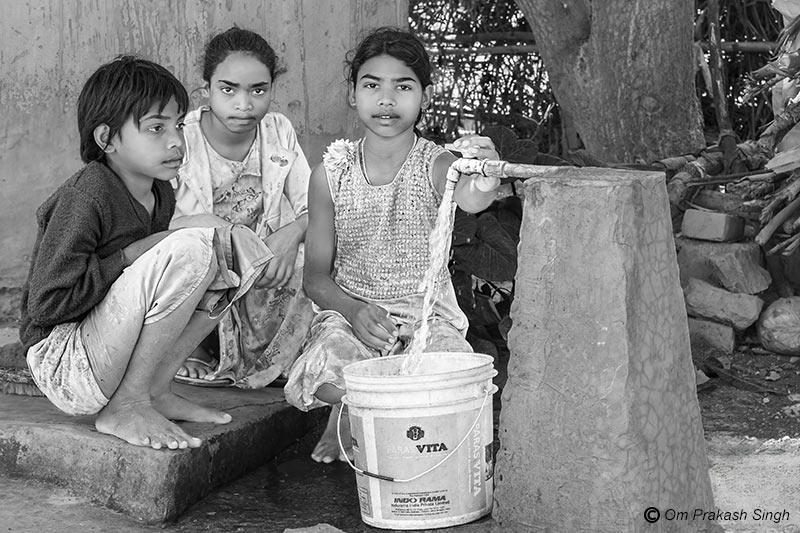 Girl children fetching water from an FHTC installed under Jal Jeevan Mission (JJM) in Seraikela-Kharsawan district, Jharkhand, India
